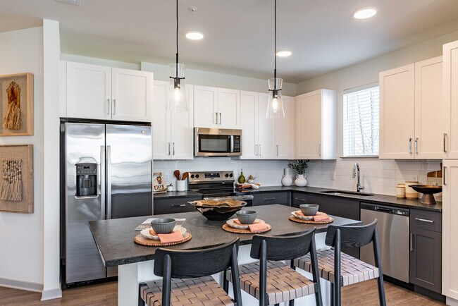 Sleek modern kitchen with stainless steel appliances. - Livano Nations