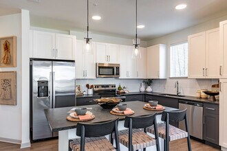 Sleek modern kitchen with stainless steel appliances. - Livano Nations