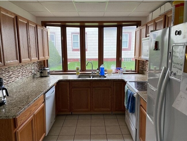 New kitchen with granite countertops, backsplash and built-in appliances - 2522 College St