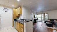 Located at 725 S Bixel St in Los Angeles, this well-appointed 2-bedroom, 3-bathroom residence offers a thoughtfully designed single-floor layout. The open-concept living and dining area is anchored by warm hardwood flooring, crown molding, and a sliding glass door that leads to a private balcony with greenery views, filling the space with natural light. The kitchen features light wood cabinetry, dark granite countertops, stainless steel appliances including a gas range, microwave, and refrigerator, along with a peninsula with bar seating — ideal for casual dining. The dedicated dining area accommodates a full-sized table and benefits from track lighting and crown molding details. Both bedrooms are comfortably sized, with large windows that invite natural light and views of surrounding greenery. The primary bedroom includes ample space and access to a well-appointed bathroom featuring a combination tub and shower, wood vanity cabinetry, and tile flooring. Two closets provide generous storage throughout the unit. With three full bathrooms, clean finishes, and a practical floor plan, this residence offers comfortable urban living in the heart of Los Angeles.