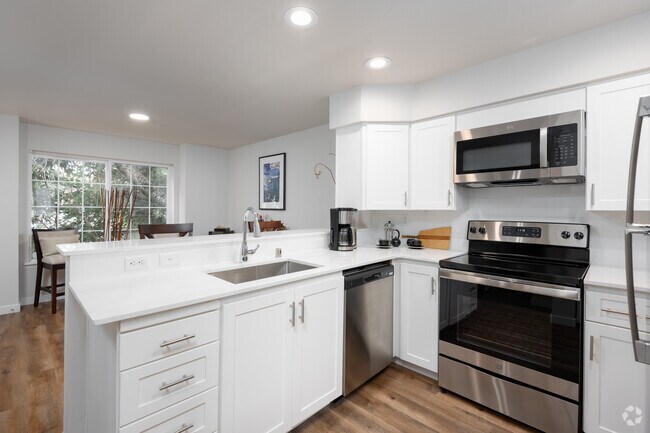 Beautifully renovated kitchens with quartz countertops - Water's Edge Townhomes