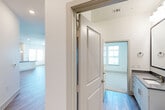 Located at 1700 Katy Fort Bend Road in Katy, TX, this well-appointed 2-bedroom, 2-bathroom residence offers a thoughtfully designed single-floor layout with a clean, contemporary aesthetic throughout. The open-concept kitchen serves as the heart of the home, boasting crisp white cabinetry, a marble-style tile backsplash, quartz countertops, stainless steel appliances, and a central island with an undermount sink and stylish pendant lighting overhead. Wood-look plank flooring flows through the kitchen and living areas, adding warmth and continuity. A private balcony door with adjacent windows draws in abundant natural light and connects the interior to the outdoors. Both bedrooms are comfortably sized and finished with plush carpeting and window blinds that offer views of the surrounding neighborhood. The primary bedroom includes access to a dedicated walk-in closet fitted with wire shelving for practical storage. The two bathrooms are finished with light wood-look flooring and quartz-topped vanities; one features full-wall marble-style tile surrounding a soaking tub, while the other offers a bright, windowed layout. Overall, the residence presents a bright, neutral palette with modern finishes that create a clean and inviting living environment.
