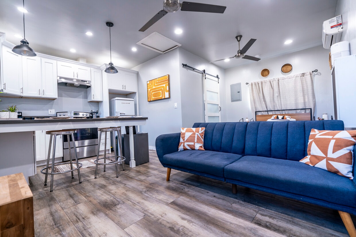 View from entrance, features one-click sofa bed, and full view of unit. barn door leads to bathroom. - 6403 Arlington Ave