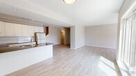 Located at 1400 Riverbend Road, Unit 37 in London, Ontario, this modern 3-bedroom, 3-bathroom townhouse offers 1,430 square feet of living space distributed across three floors. The ground floor entry level encompasses 160 square feet and provides access to the main living areas via a staircase. The main floor spans 710 square feet and centers on an open-concept kitchen and living room. The kitchen features white cabinetry, a subway tile backsplash, quartz-style countertops, stainless steel appliances including a refrigerator and range, and a peninsula with a double undermount sink. The living area offers light hardwood-style flooring, neutral taupe walls, and sliding glass doors that open to an outdoor space, alongside a secondary window that fills the room with natural light. The upper floor covers 560 square feet and houses all three bedrooms, including a primary bedroom of 140 square feet, along with the remaining bathrooms and a closet. Bedrooms feature neutral carpet, large windows with exterior views, and ample storage including built-in closets. Bathrooms are finished with clean white surrounds, one offering a soaker tub-shower combo and another featuring a standalone glass-enclosed shower stall. Four staircases connect the multi-level layout, complemented by two hallways for efficient circulation throughout the home.