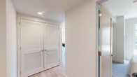 Located at 1201 Callowhill St in Philadelphia's vibrant Callowhill neighborhood, this 2-bedroom, 2-bathroom unit offers a thoughtfully designed single-floor layout with a clean, contemporary aesthetic. Light wood flooring and a neutral color palette flow seamlessly throughout, creating a bright and cohesive atmosphere.

The open-concept kitchen is a standout feature, outfitted with white flat-panel cabinetry, warm wood accents, a white quartz waterfall island with seating for three, stainless steel appliances, subway tile backsplash, and pendant lighting. The adjacent living room benefits from multiple large windows that frame views of the surrounding Philadelphia streetscape, flooding the space with natural light.

Both bedrooms are well-proportioned and serene, featuring large windows with urban views, light wood flooring, and soft neutral walls. The primary bedroom receives ample natural light from a street-facing window, providing a calm and restful retreat.

Each bathroom is finished with floating wood-toned vanities, backlit mirrors, and light wood-look flooring. One bathroom features a glass-enclosed walk-in shower with large-format tile, while the second includes a tub-shower combination. A connecting hallway links the rooms efficiently, completing the functional and modern layout of this Philadelphia residence.