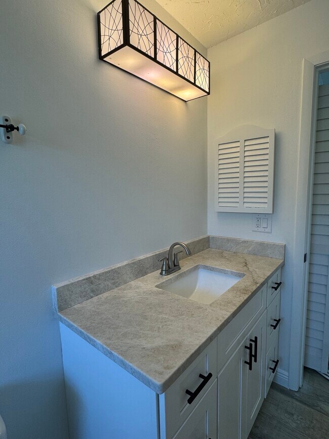 The guest bath room is located next to the guest room and the linen closet. - 4142 Iola Dr