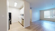 Located at 401 S La Fayette Park Place in Los Angeles, CA, this 2-bedroom, 2-bathroom unit offers a well-organized, single-level layout designed for comfortable urban living. Light wood-tone flooring runs consistently throughout the space, creating a cohesive and bright atmosphere.

The open living area is spacious and airy, connecting seamlessly to the galley-style kitchen. The kitchen is well-appointed with white cabinetry, white countertops, stainless steel appliances including a gas range, microwave, refrigerator, and dishwasher, along with a double basin sink — providing a fully functional cooking space.

The primary bedroom is generously sized, featuring sliding glass doors that open onto a private balcony with outdoor views, adding a distinct sense of openness. The second bedroom offers ample space and is filled with natural light through a large window with vertical blinds.

Both bathrooms maintain a clean, modern aesthetic with light wood flooring, white vanities, and shower-tub combinations. A hallway connects the rooms efficiently, contributing to the unit's practical flow.

Throughout the space, neutral wall tones and consistent flooring choices create a calm, move-in-ready environment suited for a wide range of lifestyles in the heart of Los Angeles.