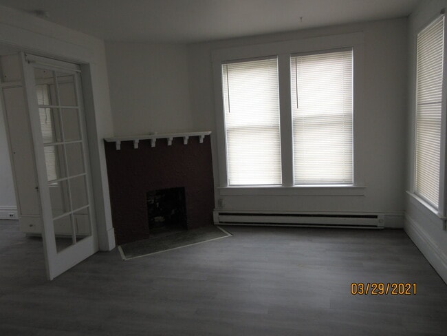 living room with decorative fireplace - 1122 S Walnut St