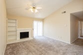 Located at 3100 Caldera Blvd in Midland, Texas, this single-story residence offers a thoughtfully laid-out floor plan with warm, neutral tones throughout. The spacious living room is a standout feature, boasting vaulted ceilings, plush carpeting, and a tile-surround fireplace flanked by built-in shelving — ideal for both display and storage. A ceiling fan with light kit keeps the space comfortable, while a sliding glass door with vertical blinds allows abundant natural light and provides access to the outdoors. An additional carpeted room offers flexibility as a bedroom or secondary living space, featuring a ceiling fan and a window with blinds that invites natural light. The kitchen is functional and well-appointed, equipped with warm wood cabinetry, laminate countertops, a double-basin stainless steel sink, a dishwasher, and an electric range with overhead ventilation. The bathrooms feature tub/shower combinations with tiled surrounds, wood-look flooring, wood vanity cabinetry, and wall mirrors. Textured ceilings are present throughout the home, contributing to its classic residential character. This straightforward, single-level layout offers comfortable living in a convenient Midland location.