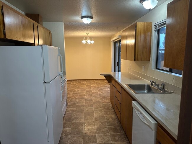 kitchen with fridge freezer, oven and dishwasher - 6439 Armar Rd