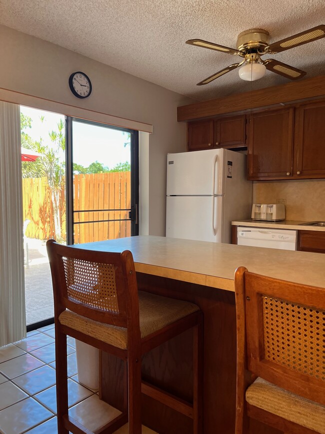 Kitchen view dishwasher refrigerator - 5830 SE Windsong Ln