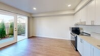 Located at 607 47th St SE in Everett, Washington, this 2-bedroom, 1-bathroom unit offers a thoughtfully designed single-floor layout that makes efficient use of its intimate footprint. Light wood-style flooring runs consistently throughout the space, lending warmth and visual continuity from room to room.

The kitchen is a standout feature, equipped with stainless steel appliances including a range, dishwasher, and refrigerator, complemented by clean white cabinetry and recessed lighting. The open arrangement allows the kitchen to flow naturally into the adjacent living area, which benefits from a sliding glass door that invites natural light and provides outdoor access.

The two bedrooms are simply finished with neutral-toned walls and the same light flooring found throughout. The primary bedroom includes a double sliding-door closet for storage, while a window allows natural light to brighten the room. Both bedrooms connect to the hallways that guide circulation through the unit.

The bathroom is clean and functional, featuring a full tub-shower combination with a curtain rod, chrome fixtures, and a window that provides ventilation and additional natural light. The warm beige wall tones throughout the unit create a calm, cohesive ambiance. Two hallways help define the unit's layout and connect its key spaces efficiently.