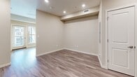 Located at 1122 Albion St in Denver's 80220 neighborhood, this well-appointed one-bedroom, one-bathroom residence is thoughtfully designed to maximize every inch of its compact footprint. The open-concept layout seamlessly integrates the living room, dining area, and kitchen into a single cohesive space, creating a comfortable and functional environment. Warm-toned luxury vinyl plank flooring runs throughout the living areas, complemented by recessed lighting and neutral wall tones that lend a clean, contemporary feel.

The kitchen is a standout feature, outfitted with rich dark-wood cabinetry, light countertops, a tile backsplash, and a full suite of stainless steel appliances including a French door refrigerator, electric range, built-in microwave, and dishwasher. A dedicated laundry nook conveniently houses a stacked washer and dryer unit just off the kitchen. The bedroom offers a cozy, private retreat with a window for natural light and access to multiple closets, providing ample storage throughout the unit. The bathroom features large-format white wall tile in the tub-shower surround, a modern vanity with matching dark cabinetry, and light tile flooring, creating a clean and polished finish.