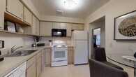 Located at 38360 Tamarac Blvd in Willoughby, Ohio, this single-floor residence offers a thoughtfully designed layout with a range of functional living spaces. The kitchen is outfitted with light wood cabinetry providing generous storage, a full suite of white appliances including a range, built-in microwave, refrigerator, and dishwasher, along with a stainless steel sink and light-toned countertops. The living room features soft carpeting, a large window allowing natural light to fill the space, and a ceiling fan, creating a warm and comfortable atmosphere. A dedicated dining area is conveniently adjacent to the living room. The bedrooms are carpeted and well-proportioned, with windows that bring in natural views of the surrounding greenery, contributing to a calm and restful environment. Two full bathrooms serve the residence — one with a shower-tub combination and tile flooring, and another with a walk-in shower and light wood vanity cabinetry. A utility room houses the water heater and offers additional functional space. The overall design is neutral and understated, with consistent warm tones throughout, making this a practical and comfortable home in the Willoughby area.