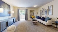This single-floor residence offers a thoughtfully designed layout that balances comfort and functionality throughout. The living room serves as the heart of the home, featuring plush carpeting, a textured ceiling, and a sliding glass door that fills the space with natural light and leads to an outdoor balcony. A built-in shelving niche adds both character and practical display space to the living area. Adjacent to the living room, a dedicated dining area provides a comfortable space for meals, accented by a ceiling fan and bright, neutral walls. The galley-style kitchen is efficiently organized with warm wood cabinetry, white countertops, tile flooring, and a full suite of white appliances including a refrigerator, range, and dishwasher. A pass-through connects the kitchen to the living area, enhancing the open feel. The bedroom is a relaxing retreat with soft carpet, a ceiling fan, and a window dressed with patterned curtains. The full bathroom features tile flooring, a single-sink vanity with wood cabinetry, a white countertop, and a tub-shower combination. Completing the unit is a dedicated in-unit laundry area with tile flooring and washer/dryer hookups, offering added convenience.