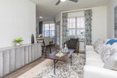 Located at 105 Oak Hill Dr in Athens, Georgia, this single-floor residence offers a thoughtfully designed layout with modern finishes and a cohesive, neutral aesthetic throughout. The galley-style kitchen is outfitted with white shaker cabinetry, granite countertops, subway tile backsplash, and stainless steel appliances, providing ample workspace and storage. Wood-style flooring runs through the main living and kitchen areas, adding warmth and continuity to the space. The living room is bright and welcoming, featuring a ceiling fan, large windows that invite natural light, and enough space to comfortably accommodate multiple seating arrangements. The bedrooms are carpeted for comfort, each offering ceiling fans, natural light from well-positioned windows, and closet access — including at least one walk-in closet. The bathrooms are finished with granite-topped vanities, white cabinetry with brushed nickel hardware, and tub-shower combinations with tile surrounds. Both bathrooms reflect a clean, contemporary design. Overall, the residence presents a polished, move-in-ready interior with consistent attention to detail, making it a functional and attractive living space in the Athens, GA community.