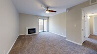 Located at 10700 Academy Rd NE in Albuquerque, New Mexico, this single-floor, 2-bedroom, 3-bathroom home offers a well-organized and comfortable layout. The open-concept living room and kitchen area creates a welcoming central hub, with plush carpeting, a ceiling fan, and a fireplace anchoring the living space. A sliding glass door leads to an outdoor area, allowing natural light to flow in. The kitchen is appointed with white cabinetry, granite-style countertops, stainless steel appliances including a range, microwave, and refrigerator, and wood-look flooring that adds warmth to the space. Both bedrooms are generously proportioned, featuring soft carpeting, ceiling fans, and windows with blinds that bring in natural light. The spacious primary bedroom offers a comfortable retreat. The bathrooms are well-appointed, with one featuring a full tub-shower combination with classic white tile surround, and another showcasing a wide vanity with granite-style countertops, white cabinetry, and a large mirror. A dedicated closet and hallway complete the thoughtfully designed floor plan, offering practical storage and smooth flow between all rooms.