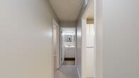 This 430 square foot apartment in Seattle offers a thoughtful layout that maximizes every inch of space. The primary bedroom, an impressive 270 square feet, provides ample room for rest and relaxation. The living area features neutral tones with plush carpeting, creating a cozy atmosphere. Large windows allow natural light to flood the space, enhancing the sense of openness.

The kitchen, while compact, is efficiently designed with white cabinetry and durable countertops. A stainless steel sink and modern faucet add a touch of sophistication. The bathroom showcases a contemporary design with marble-look tile surrounding the bathtub and shower combination, complemented by wood-look flooring for warmth.

A standout feature is the in-unit laundry, a rare amenity in apartments of this size. The hallway provides additional storage options. Located at 10500 Meridian Ave N in Seattle, this single-floor unit offers a perfect blend of functionality and comfort in an urban setting.
