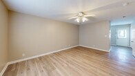 Located at 160 Stateline Rd in Clarksville, TN, this two-story home offers a practical and comfortable layout spread across two well-proportioned floors. The main level features a functional kitchen equipped with warm honey-toned oak cabinetry, ample upper and lower cabinet storage, a double sink, and white appliances including a range, built-in microwave, and dishwasher. The kitchen flows into the main living area, which is finished with light wood-look laminate flooring and a ceiling fan, creating a bright and airy atmosphere. A full bathroom on the main level includes a tub-shower combo with clean white surrounds. Upstairs, two carpeted bedrooms offer a cozy retreat, each featuring ceiling fans and windows that bring in natural light. The primary bedroom provides a generous footprint with a double-door closet for ample storage. The second bedroom also features a closet and a window with exterior views. A second full bathroom on the upper level includes a wood-toned vanity with a single sink and mirror. Neutral wall tones, white trim, and six-panel doors are consistent throughout, lending the home a clean, cohesive aesthetic.