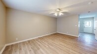 Located at 160 Stateline Rd in Clarksville, TN, this two-story home offers a practical and comfortable layout spread across two well-proportioned floors. The main level features a functional kitchen equipped with warm honey-toned oak cabinetry, ample upper and lower cabinet storage, a double sink, and white appliances including a range, built-in microwave, and dishwasher. The kitchen flows into the main living area, which is finished with light wood-look laminate flooring and a ceiling fan, creating a bright and airy atmosphere. A full bathroom on the main level includes a tub-shower combo with clean white surrounds. Upstairs, two carpeted bedrooms offer a cozy retreat, each featuring ceiling fans and windows that bring in natural light. The primary bedroom provides a generous footprint with a double-door closet for ample storage. The second bedroom also features a closet and a window with exterior views. A second full bathroom on the upper level includes a wood-toned vanity with a single sink and mirror. Neutral wall tones, white trim, and six-panel doors are consistent throughout, lending the home a clean, cohesive aesthetic.