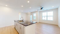 Located at 8006 Cedar Creek Rd in Louisville, Kentucky, this well-appointed one-bedroom, one-bathroom residence offers a thoughtfully designed layout across a single floor. The open-concept kitchen and living area serves as the heart of the home, featuring light hardwood-style flooring that flows seamlessly throughout. The kitchen is highlighted by crisp white shaker cabinetry, dark granite countertops, a central island with an undermount sink, and a full suite of stainless steel appliances, including a refrigerator, range, microwave, and dishwasher. Recessed lighting illuminates the space with a clean, modern feel. The living area is bright and airy, benefiting from multiple large windows dressed with white blinds, a ceiling fan, and direct access to a private exterior balcony. The spacious bedroom is carpeted for comfort and features two windows that invite natural light, along with access to a generously sized walk-in closet equipped with multi-level wire shelving. The full bathroom offers a granite-topped vanity with grey cabinetry, a tub-shower combo, and light wood-look flooring. A dedicated laundry area with a full-size washer and dryer completes this efficiently designed and move-in-ready home.