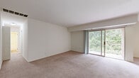 Located at 2000 Maplewood Drive in York, PA, this single-floor residence offers a well-organized layout comprising three bedrooms, one bathroom, a kitchen, dining room, hallway, entrance, and a closet. The living area features soft wall-to-wall carpeting and large sliding glass doors that open onto a private balcony, where leafy tree views create a serene, nature-filled backdrop. Natural light flows freely throughout the space, enhancing its clean, neutral aesthetic.

The kitchen is equipped with dark shaker-style cabinetry, stainless steel appliances including a gas range, built-in microwave, and refrigerator, complemented by light wood-tone flooring that adds warmth to the space. The bedrooms are carpeted and bright, each featuring windows with views of the surrounding greenery. The generously sized primary bedroom offers ample space, while the additional bedrooms include features such as ceiling fans and built-in closets.

The bathroom is finished with white cabinetry, a combined tub and shower, and wood-look flooring, presenting a clean and contemporary feel. Throughout the residence, a consistent palette of white and neutral tones creates a cohesive and inviting atmosphere, making this a comfortable and practical home in a green setting.