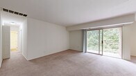 Located at 2000 Maplewood Drive in York, PA, this single-floor residence offers a well-organized layout comprising three bedrooms, one bathroom, a kitchen, dining room, hallway, entrance, and a closet. The living area features soft wall-to-wall carpeting and large sliding glass doors that open onto a private balcony, where leafy tree views create a serene, nature-filled backdrop. Natural light flows freely throughout the space, enhancing its clean, neutral aesthetic.

The kitchen is equipped with dark shaker-style cabinetry, stainless steel appliances including a gas range, built-in microwave, and refrigerator, complemented by light wood-tone flooring that adds warmth to the space. The bedrooms are carpeted and bright, each featuring windows with views of the surrounding greenery. The generously sized primary bedroom offers ample space, while the additional bedrooms include features such as ceiling fans and built-in closets.

The bathroom is finished with white cabinetry, a combined tub and shower, and wood-look flooring, presenting a clean and contemporary feel. Throughout the residence, a consistent palette of white and neutral tones creates a cohesive and inviting atmosphere, making this a comfortable and practical home in a green setting.