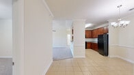Located at 196 Winter Forest Dr in Candler, NC, this single-story, 3-bedroom, 2-bathroom home offers a well-designed layout with a comfortable flow between living spaces. The open-concept kitchen, dining, and living area forms the heart of the home, with light tile flooring underfoot and crown molding adding a refined architectural touch. The kitchen is equipped with rich medium-toned wood cabinetry, granite countertops, and black appliances, including a range with over-the-range microwave and a refrigerator. A decorative column separates the kitchen from the carpeted living room, which features a ceiling fan and flows into the dining area. The generously sized primary bedroom includes a vaulted ceiling, a ceiling fan, a large window with natural light and outdoor views, and a spacious walk-in closet with wire shelving. The additional bedrooms are carpeted and offer ample space. The bathrooms feature tile flooring, wood vanities with granite countertops, and tub-shower combinations. A dedicated laundry room with tile flooring and wire shelving adds everyday convenience. Three closets throughout the home provide excellent storage.