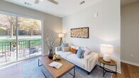 Located on Ileagnes Road in Raleigh, NC, this single-floor residence offers a well-designed layout with modern finishes throughout. The kitchen is a standout feature, outfitted with gray shaker-style cabinetry, granite countertops, a patterned tile backsplash, and a full suite of stainless steel appliances. A peninsula with pendant lighting and bar seating connects the kitchen to the main living area, making it ideal for both cooking and entertaining. The living room is bright and welcoming, with wood-look flooring, a ceiling fan, and a sliding glass door that opens to a private balcony with outdoor views of surrounding greenery. The bedrooms are carpeted for comfort, each offering natural light through large windows with blinds and ceiling fans. The primary bedroom provides a calm retreat with neutral tones and ample space. Bathrooms feature granite vanity tops, gray cabinetry, wood-look tile flooring, and tub-shower combinations. A carpeted hallway connects the bedrooms and provides access to closet space. Throughout the residence, a consistent palette of soft whites and grays creates a clean, contemporary ambiance suited for comfortable everyday living.