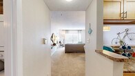 Located at 2821 Carlisle Street in Dallas, TX, this one-bedroom, one-bathroom residence offers a thoughtfully organized single-floor layout that maximizes every square foot. The living room serves as the heart of the home, featuring plush carpeting, a large window with blinds and sheer curtains that invite natural light, and a cozy fireplace — creating a warm and inviting atmosphere. A dedicated dining area sits adjacent, anchored by a stylish pendant light and open to the kitchen via a convenient pass-through counter, making it ideal for entertaining. The galley-style kitchen is equipped with light maple cabinetry, granite-style countertops, a tile backsplash, hardwood-style flooring, and black appliances including a refrigerator and stove. The bedroom is a comfortable retreat with soft carpeting, a ceiling fan, and a window with natural light. Two closets provide ample storage throughout the unit. The full bathroom features a granite-topped vanity with maple cabinetry, tile-surround tub-shower combination, and tile flooring. Two hallways connect the spaces efficiently, completing a layout that is both functional and comfortable.