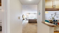 Located at 2821 Carlisle Street in Dallas, TX, this one-bedroom, one-bathroom residence offers a thoughtfully organized single-floor layout that maximizes every square foot. The living room serves as the heart of the home, featuring plush carpeting, a large window with blinds and sheer curtains that invite natural light, and a cozy fireplace — creating a warm and inviting atmosphere. A dedicated dining area sits adjacent, anchored by a stylish pendant light and open to the kitchen via a convenient pass-through counter, making it ideal for entertaining. The galley-style kitchen is equipped with light maple cabinetry, granite-style countertops, a tile backsplash, hardwood-style flooring, and black appliances including a refrigerator and stove. The bedroom is a comfortable retreat with soft carpeting, a ceiling fan, and a window with natural light. Two closets provide ample storage throughout the unit. The full bathroom features a granite-topped vanity with maple cabinetry, tile-surround tub-shower combination, and tile flooring. Two hallways connect the spaces efficiently, completing a layout that is both functional and comfortable.