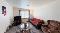 Located at 617 Lucinda Ave in DeKalb, Illinois, this single-floor unit offers a practical and comfortable layout well-suited for everyday living. The living room serves as the central gathering space, featuring wood-look flooring, a large window with blinds and patterned curtains that invite natural light, and ample room for seating and entertainment.

The kitchen is efficiently designed in an L-shaped configuration, outfitted with dark wood cabinetry providing generous storage, a double sink, electric range, refrigerator, and under-cabinet lighting. The wood-look flooring continues seamlessly throughout the space, lending a cohesive feel.

Multiple bedrooms offer flexible living arrangements. Each room features wood-look flooring, neutral walls, and closets with folding doors equipped with hanging rods for organized storage. Windows in select bedrooms provide views to the outdoors and allow natural light to filter in.

The bathroom includes a full tub and shower combination with a curtain rod, a toilet, and a vanity with warm wood cabinetry. The overall layout of the unit is straightforward and functional, making it a practical option for residents seeking convenient access to Northern Illinois University and the surrounding DeKalb community.