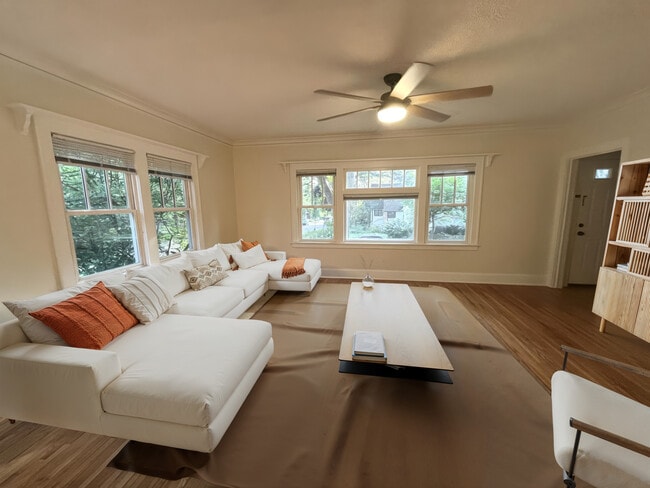 Living room with cheesy AI staging - 1633 E River Ter