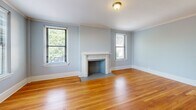 Located at 870 Vine St in Chattanooga, Tennessee, this well-appointed 2-bedroom, 2-bathroom residence offers a comfortable and cohesive single-floor layout. Throughout the home, warm-toned hardwood floors and soft blue-gray walls create a calm, consistent aesthetic complemented by crisp white trim and crown molding.

The dual living areas are bright and open, benefiting from multiple windows that invite natural light and offer pleasant outdoor views of the surrounding neighborhood. The kitchen features white cabinetry, light quartz countertops, tile flooring, and stainless steel appliances, providing a clean and functional workspace.

Both bedrooms are generously proportioned, with the spacious primary bedroom offering ample room for a full furniture arrangement. Each bedroom includes louvered closet doors and windows with views of the greenery outside. Multiple hallways connect the rooms efficiently, contributing to a smooth flow throughout the home.

The two bathrooms are tastefully finished with classic octagonal mosaic tile flooring, white vanities with framed mirrors, and tiled shower surrounds. One bathroom includes a tub-shower combination with a natural light window, while the other features a walk-in tiled shower. Built-in shelving provides additional storage. The overall ambiance is clean, bright, and move-in ready.