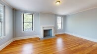 Located at 870 Vine St in Chattanooga, Tennessee, this well-appointed 2-bedroom, 2-bathroom residence offers a comfortable and cohesive single-floor layout. Throughout the home, warm-toned hardwood floors and soft blue-gray walls create a calm, consistent aesthetic complemented by crisp white trim and crown molding.

The dual living areas are bright and open, benefiting from multiple windows that invite natural light and offer pleasant outdoor views of the surrounding neighborhood. The kitchen features white cabinetry, light quartz countertops, tile flooring, and stainless steel appliances, providing a clean and functional workspace.

Both bedrooms are generously proportioned, with the spacious primary bedroom offering ample room for a full furniture arrangement. Each bedroom includes louvered closet doors and windows with views of the greenery outside. Multiple hallways connect the rooms efficiently, contributing to a smooth flow throughout the home.

The two bathrooms are tastefully finished with classic octagonal mosaic tile flooring, white vanities with framed mirrors, and tiled shower surrounds. One bathroom includes a tub-shower combination with a natural light window, while the other features a walk-in tiled shower. Built-in shelving provides additional storage. The overall ambiance is clean, bright, and move-in ready.