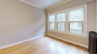 This 430 square foot one-bedroom apartment in Milwaukee offers a blend of modern amenities and classic charm. The kitchen, a focal point of the space, boasts white cabinetry, granite countertops, and stainless steel appliances, creating a sleek and efficient cooking area. The living room and bedroom are illuminated by large windows, providing ample natural light and views of the surrounding urban landscape. Hardwood floors throughout add warmth and character, while vintage radiators hint at the building's history. The bathroom features a clean, contemporary design with a white vanity and a tub/shower combination. Despite its compact size, the apartment's layout is well-thought-out, with each area serving a distinct purpose. The 120 square foot bedroom offers cozy quarters for rest, while built-in closets provide essential storage. Located at 913 E Kilbourn Ave, this apartment combines the convenience of city living with the comfort of a well-designed personal space.