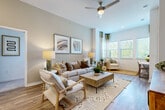 This single-story, two-bedroom, two-bathroom residence in Pelham, Alabama, offers a thoughtfully designed layout with modern finishes throughout. The open living area features soaring ceilings, wood-style flooring, and generous natural light streaming through multiple windows. A ceiling fan adds practicality, while neutral tones create a calm, welcoming ambiance.

The kitchen is well-appointed with gray cabinetry, granite countertops, stainless steel appliances, pendant lighting, and a breakfast bar island that provides additional seating and workspace. An adjacent flex area accommodates a home office setup, adding versatility to the floor plan.

Both bedrooms are carpeted and generously sized, each featuring high ceilings, large windows with outdoor views, and ceiling fans. Each bedroom connects to its own private bathroom, finished with granite-topped dual vanities, gray cabinetry, wood-style flooring, large mirrors, and a tiled walk-in shower. The clean, modern aesthetic is consistent throughout both bathrooms.

Overall, the residence presents a cohesive, contemporary design with quality finishes, functional spaces, and an airy atmosphere enhanced by elevated ceilings and abundant natural light.