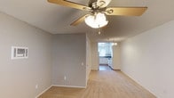 Located at 845 Vine St in Oceanside, Unit #39 is a single-floor residence designed with a practical and comfortable layout. The living area features neutral-toned carpet flooring and a ceiling fan with integrated lighting, creating a relaxed and airy atmosphere. An open sightline connects the living space to the kitchen, which is outfitted with white cabinetry, dark granite-style countertops, a double-coil electric range, a dishwasher, and a stainless steel sink beneath a window that allows natural light to filter in. A chandelier-style pendant light adds a touch of character to the dining area adjacent to the kitchen. The bedrooms continue the carpeted flooring and are each equipped with ceiling fans and ample natural light from windows with blinds. One bedroom includes a built-in closet for convenient storage. The bathrooms feature wood-look hard flooring, white vanity cabinetry, dark countertops with undermount sinks, vanity lighting, and over-toilet storage. The consistent neutral color palette and clean finishes throughout the unit contribute to a cohesive and move-in-ready feel.