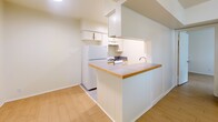 Located at 3107 Speedway Avenue in Austin, Texas, this two-bedroom, one-bathroom residence offers a practical and efficient single-floor layout. Light wood-style flooring runs throughout the main living areas and bedrooms, creating a cohesive and clean aesthetic across the space.

The open living area is bright and airy, featuring a ceiling fan and a window that allows natural light to filter in. It connects seamlessly to the kitchen via a peninsula-style pass-through counter with a tile surface and wood-trimmed edge, making the space feel open and connected. The galley kitchen is efficiently organized with white cabinetry extending to the ceiling, a stainless steel sink, a gas range, a dishwasher, a full-size refrigerator, and a blue mosaic tile backsplash that adds a subtle decorative accent. Tile flooring in the kitchen provides a practical transition from the living area.

Both bedrooms continue the light wood flooring and are each equipped with ceiling fans. The primary bedroom offers a comfortable footprint, while both rooms benefit from natural light through windows with blinds. A dedicated closet provides additional storage.

The full bathroom features tile flooring, a vanity with cabinetry below, and clean white walls. A separate closet off the hallway adds further storage utility to this well-organized Austin residence.