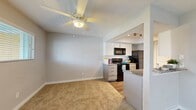 Located at Zocalo on Hammerly Blvd in Houston, TX, this 2-bedroom, 2-bathroom residence offers a practical and comfortable single-floor layout. The living room welcomes you upon entry with soft carpeted flooring, a ceiling fan with light fixture, and a window that invites natural light. It flows seamlessly into the kitchen, which features a galley-style design with granite countertops, white cabinetry, wood-look flooring, track lighting, black appliances including a range and refrigerator, and a pantry closet for additional storage. Both bedrooms are carpeted and well-proportioned, with the primary bedroom offering generous closet space — notably featuring dual closets with built-in shelving. The second bedroom includes a bright window with an exterior view. Each bathroom is finished with granite-top white vanities, dark-framed mirrors, and wood-look flooring, providing a clean and cohesive aesthetic. A dedicated laundry area with washer and dryer hookups adds everyday convenience. The hallway connects the living spaces efficiently, giving the overall layout a logical and functional flow. Neutral tones throughout create a calm, move-in-ready ambiance suitable for a variety of lifestyles.