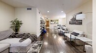 Located in the desirable West Los Angeles neighborhood of 90025, this well-appointed 2-bedroom, 3-bathroom residence offers a thoughtfully designed single-floor layout with generous living space throughout. Rich, dark hardwood floors flow seamlessly through the expansive living room, which features recessed lighting, a fireplace, and sliding glass doors that invite natural light and connect the interior to an outdoor area. The open-concept design extends toward a dedicated dining space and a well-equipped kitchen, highlighted by a tray ceiling, two-tone cabinetry with dark lower and white upper cabinets, granite countertops, stainless steel appliances including a range with hood, and large-format white tile flooring. The spacious primary bedroom offers a comfortable retreat with recessed lighting and a luxurious en-suite bathroom complete with a soaking tub, separate glass-enclosed shower, dual vanity with modern dark cabinetry, and large mirrors. A second bedroom features dark hardwood floors, a bright window with natural light, and mirrored sliding closet doors. The additional bathrooms include marble-tiled walls and a tub-shower combination with glass enclosure. Two hallways connect the spaces efficiently, and a dedicated closet adds practical storage to this polished West LA residence.