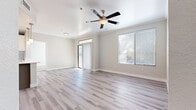 This well-appointed single-floor residence offers a clean, contemporary design throughout. The open living area is bathed in natural light, courtesy of a sliding glass door leading to a private balcony and large windows dressed with horizontal blinds. Light wood-style luxury vinyl plank flooring flows seamlessly through the main living spaces, complemented by neutral-toned walls and crown molding. A ceiling fan adds both function and style to the living area.

The kitchen is outfitted with stainless steel appliances — including a range and over-the-range microwave — paired with white upper cabinetry and gray lower cabinets atop light countertops, creating a crisp, modern aesthetic.

The bedrooms feature plush carpeting and receive ample natural light through windows with blinds. A generously sized walk-in closet offers extensive built-in shelving and hanging rods, providing abundant storage. The bathroom presents a refined finish with a granite-style countertop, undermount sink, gray shaker-style vanity cabinetry, brushed nickel fixtures, and a large framed mirror.

A dedicated laundry area conveniently houses a full-size washer and dryer. The light wood-style flooring in the utility hall maintains design continuity throughout the home, creating a cohesive and polished living environment.