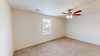 Located at 135 Old Gray Station Rd in Johnson City, TN, this single-floor, one-bedroom, one-bathroom unit offers a smart and functional layout designed to maximize every square foot. The kitchen is a standout feature, equipped with rich dark-stained cabinetry, light granite-style countertops, stainless steel appliances including a range, microwave, and refrigerator, and a peninsula with an integrated sink and pendant lighting overhead. Light wood-look flooring in the kitchen transitions seamlessly into the living area. The living space is carpeted and bright, featuring a ceiling fan with light kit and access to an exterior door with a window that invites natural light. The bedroom is a comfortable retreat, also carpeted, with its own ceiling fan, a window with neighborhood views, and a closet with sliding panel doors. The bathroom features wood-look tile flooring, a dark-stained vanity with brushed nickel hardware, and a clean, open layout with a towel bar and accessible design elements. A dedicated utility room adds practical convenience. The overall aesthetic is clean, modern, and neutral, making this a well-appointed unit in Johnson City.