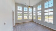 Located on Manhattan Blvd in Dayton, Kentucky, this single-floor residence offers a thoughtfully designed layout that balances openness with functional living spaces. The most striking feature is the expansive main living area, where soaring double-height ceilings meet floor-to-ceiling windows arranged across two walls. This dramatic windowed corner floods the room with abundant natural light and frames sweeping outdoor views, while a ceiling fan provides comfort overhead. Light-toned wood-style flooring runs throughout the main living areas, enhancing the airy, open feel. The kitchen is well-equipped with white shaker cabinetry, a classic subway tile backsplash, stainless steel appliances including a refrigerator, range, and microwave, and a large center island with quartz countertops and an undermount sink. Pendant and track lighting complete the kitchen's modern aesthetic. The bedrooms offer plush carpet flooring and natural light through double windows, with at least one bedroom featuring a spacious walk-in closet with built-in shelving. The bathrooms are finished with quartz vanity countertops, wood-style flooring, and tiled tub-shower combinations. Clean, neutral tones throughout create a cohesive and move-in-ready environment suited for comfortable everyday living.