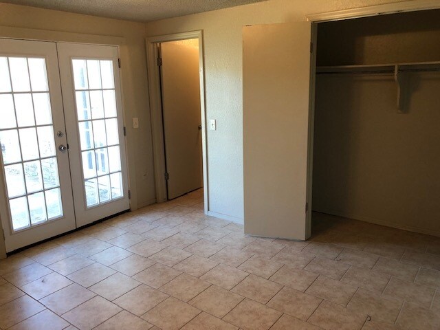 Bedroom 2 view of closet and French doors to backyard - 12409 SW 2nd St