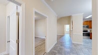 Located at 201 Tiliwa Ct in Clemson, SC, this single-floor, 2-bedroom, 2-bathroom home offers a thoughtfully designed layout with a warm and neutral color palette throughout. Light beige walls and crisp white trim create a clean, cohesive aesthetic across every room.

The kitchen is a standout feature, equipped with rich cherry wood cabinetry, granite countertops, stainless steel appliances, and tile flooring — offering both style and functionality. The adjacent dining room is finished with the same tile flooring and accented by elegant crown molding and a classic chandelier, adding a refined touch to mealtimes.

The living areas flow seamlessly through a well-proportioned hallway with vaulted ceilings, enhancing the sense of openness. The primary bedroom is notably spacious, boasting vaulted ceilings and a ceiling fan, while the second bedroom features its own ceiling fan and a window that brings in natural light with outdoor views of surrounding greenery.

Both bathrooms are finished with tile flooring, granite-topped vanities with rich wood cabinetry, and tub-shower combinations. The dedicated laundry room adds everyday convenience. Three closets provide ample storage throughout the home. Crown molding details and consistent finishes lend the entire space a polished, move-in-ready feel.