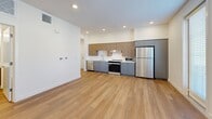 Located at 572 Gibson Dr in Roseville, CA, this thoughtfully designed one-bedroom, one-bathroom unit offers a clean, modern aesthetic throughout its efficiently arranged single-floor layout. Warm wood-look flooring flows continuously through every room, providing a cohesive and inviting foundation.

The open-concept living and kitchen area serves as the heart of the unit. The kitchen is well-appointed with a full suite of stainless steel appliances, including a refrigerator, gas range, microwave, and dishwasher. Two-toned cabinetry — combining warm wood-finish uppers with sleek gray lower cabinets — adds contemporary contrast, while white quartz countertops and a subway tile backsplash complete the polished look. Recessed lighting illuminates the space, and windows with blinds allow for natural light and privacy control.

The bedroom is a calm, minimalist retreat featuring a spacious sliding-door closet and a window with outdoor views, filling the room with natural light. The bathroom maintains the same modern design language, with a wood-vanity cabinet, white countertop, framed mirror, and wood-look flooring. A louvered utility door adds a practical, stylish touch to the unit's entryway area. Overall, the space presents a bright, clean, and contemporary living environment.