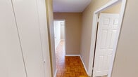 Located at 1631 Laurel Ave in Knoxville, Tennessee, this single-floor unit offers a practical and well-organized layout with consistent design details throughout. One of the most distinctive features is the warm parquet hardwood flooring that extends across the living spaces, hallways, and bedrooms, lending a classic character to the interior.

The living area is generously proportioned, featuring neutral taupe-toned walls, a ceiling fan, and a window with blinds that allows natural light to fill the room. A wall-mounted air conditioning unit provides climate control. The space connects naturally to a hallway lined with closet storage, leading to the additional rooms.

The bedrooms share the same parquet flooring and neutral wall palette, each equipped with a window and a wall-mounted A/C unit. Built-in closet space is present, providing practical storage options.

The kitchen is efficiently designed with white cabinetry extending to the ceiling, dark granite-style countertops, a double-basin stainless steel sink, and white appliances including a range and refrigerator. Stone-style tile flooring grounds the space with a durable finish.

The bathroom continues the tile flooring and features white cabinetry with a dark countertop, a single-basin vanity with a lighted mirror, a toilet, and a bathtub, all set within a clean, neutral color scheme.
