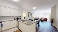 Located at 50 Laurier Ave E in Ottawa's vibrant Sandy Hill neighbourhood, this thoughtfully designed one-bedroom, one-bathroom unit offers an efficient and comfortable layout across a single floor. The open-concept kitchen and living area form the heart of the space, creating a seamless flow ideal for both everyday living and entertaining. The kitchen is outfitted with stainless steel appliances, crisp white cabinetry with subway tile backsplash, grey quartz countertops, and a peninsula with a double sink — maximizing both functionality and style. Durable hardwood-style flooring extends throughout the main living area, adding warmth and visual continuity. The living room is anchored by a striking bay window configuration that floods the space with natural light and offers views of the surrounding greenery. The generously sized bedroom provides a quiet retreat, featuring hardwood-style flooring and direct access to the full bathroom. The bathroom is finished with clean white tilework and includes a stacked in-unit washer and dryer — a highly practical convenience. Neutral tones and clean lines throughout give the space a bright, welcoming ambiance well-suited to comfortable urban living in the heart of Ottawa.