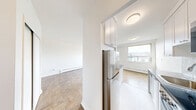 Located on the third floor of a low-rise building at 3890 Bathurst Street in Toronto's Bathurst Manor neighbourhood, this one-bedroom, one-bathroom unit offers a clean and functional layout across a single floor. The galley-style kitchen is thoughtfully designed with white shaker cabinetry extending to the ceiling, dark countertops, a subway tile backsplash, and stainless steel appliances including a dishwasher, range, and refrigerator — maximizing both storage and workspace efficiency. The living area features warm parquet flooring and a large window with a balcony door, allowing natural light to fill the space while offering views of the surrounding neighbourhood. The bedroom is a comfortable, well-proportioned room with the same parquet flooring, a large sliding-door closet, and a window that brings in additional natural light. The bathroom is finished with classic white subway tile surrounding a full soaking tub, complementing the clean, neutral palette found throughout the unit. Baseboard heating is present throughout the living and bedroom areas. The building exterior is a low-rise mid-century structure set amid mature trees, providing a relatively quiet residential setting with convenient access to Bathurst Street amenities.